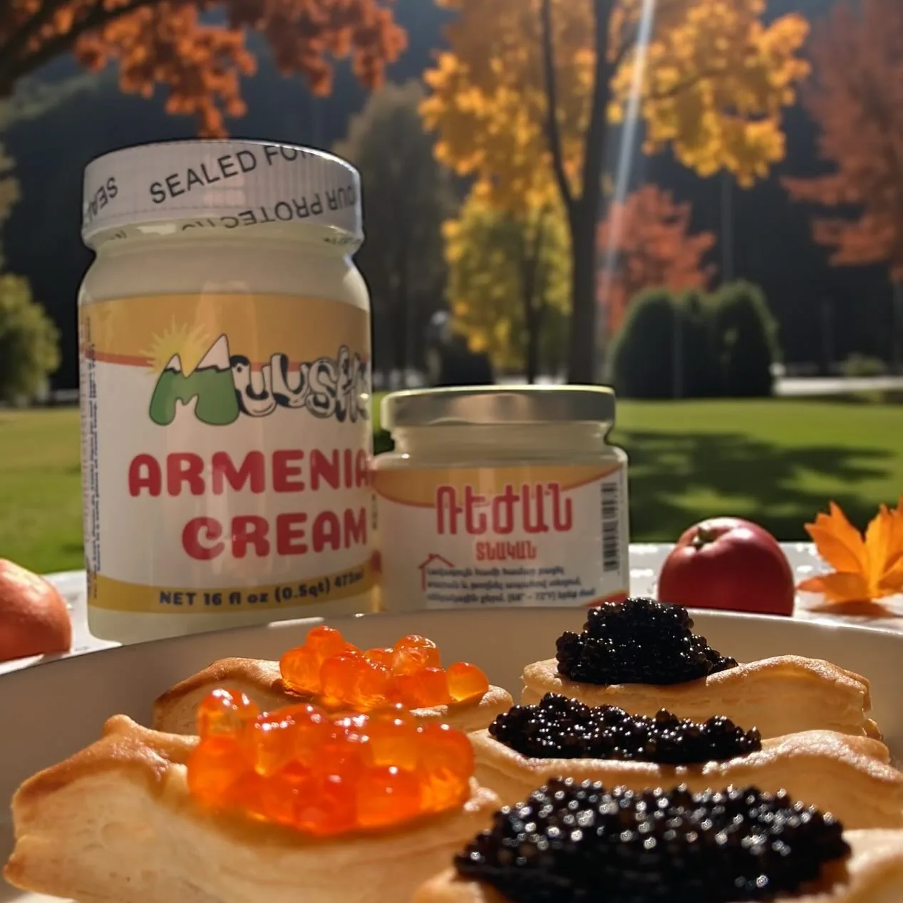 Jars of Muusho Armenian cream with tartlets topped with red and black caviar