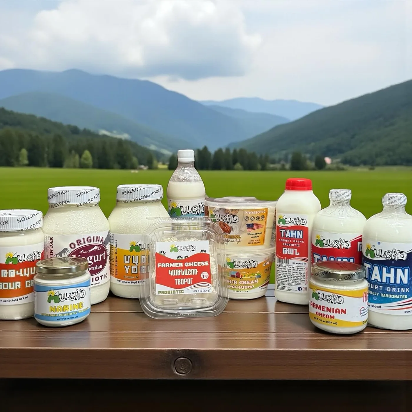 The Muusho family of products — sour cream, yogurt, Narine, farmer cheese, Armenian cream and tahn — on a wooden table in front of green mountains