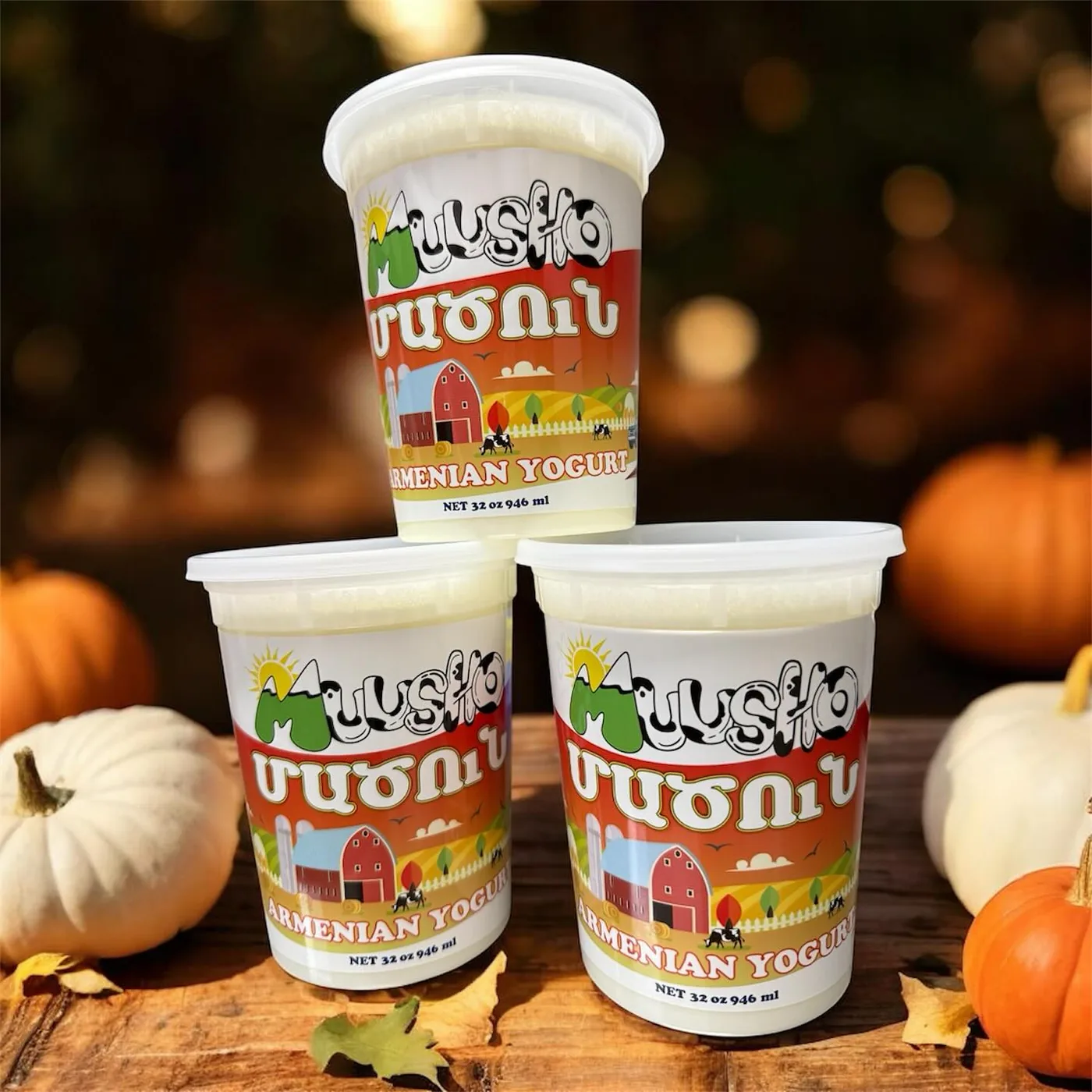 Cups of Muusho matsun stacked among small autumn pumpkins
