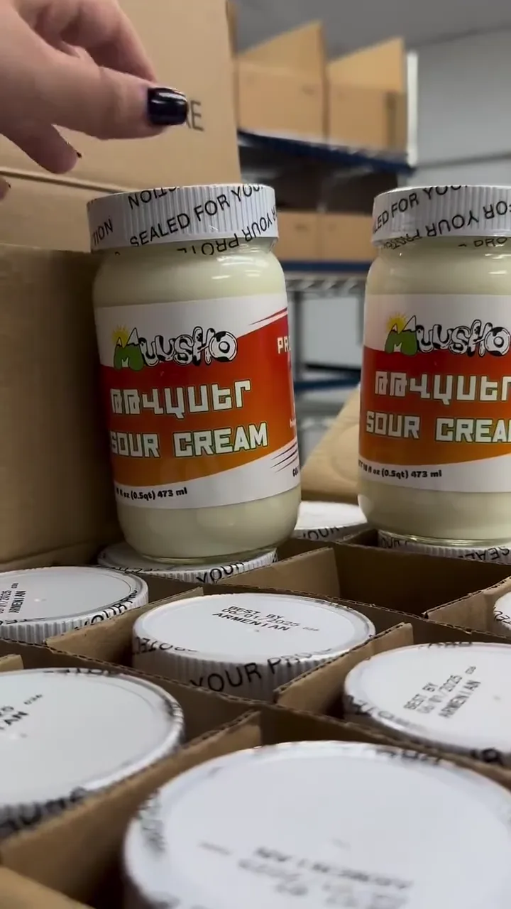 Behind the scenes: jars of Muusho sour cream being filled, sealed and packed